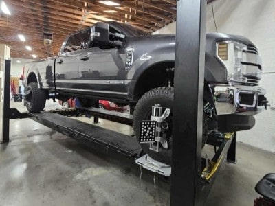 Vehicles up on lifts in the Mobile Man Auto Repair service bays