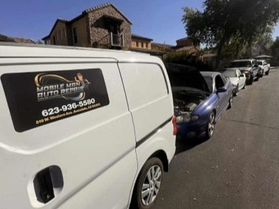 The Mobile Man Auto Repair mobile service van, lettered with the phone number and Avondale address, parked at a customer location